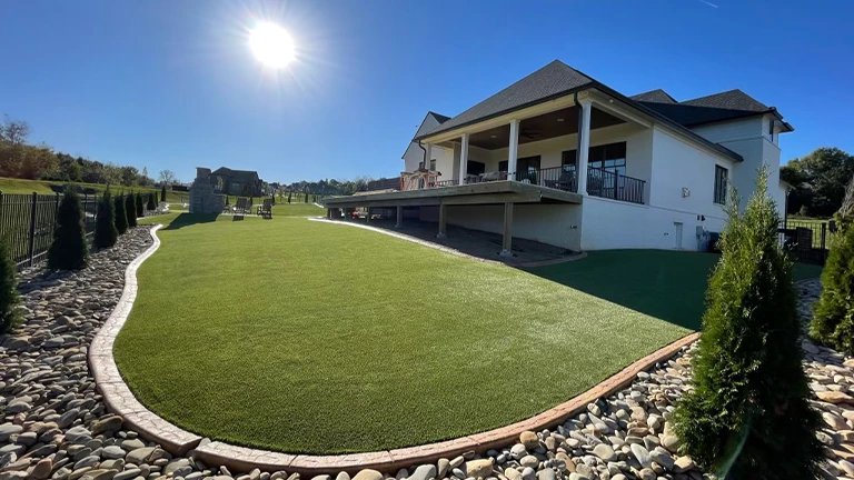 High-quality artificial turf enhancing a Knoxville home garden, blending seamlessly with natural landscape design.